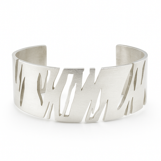 Silver cuff bracelet with cut-out design on a white background