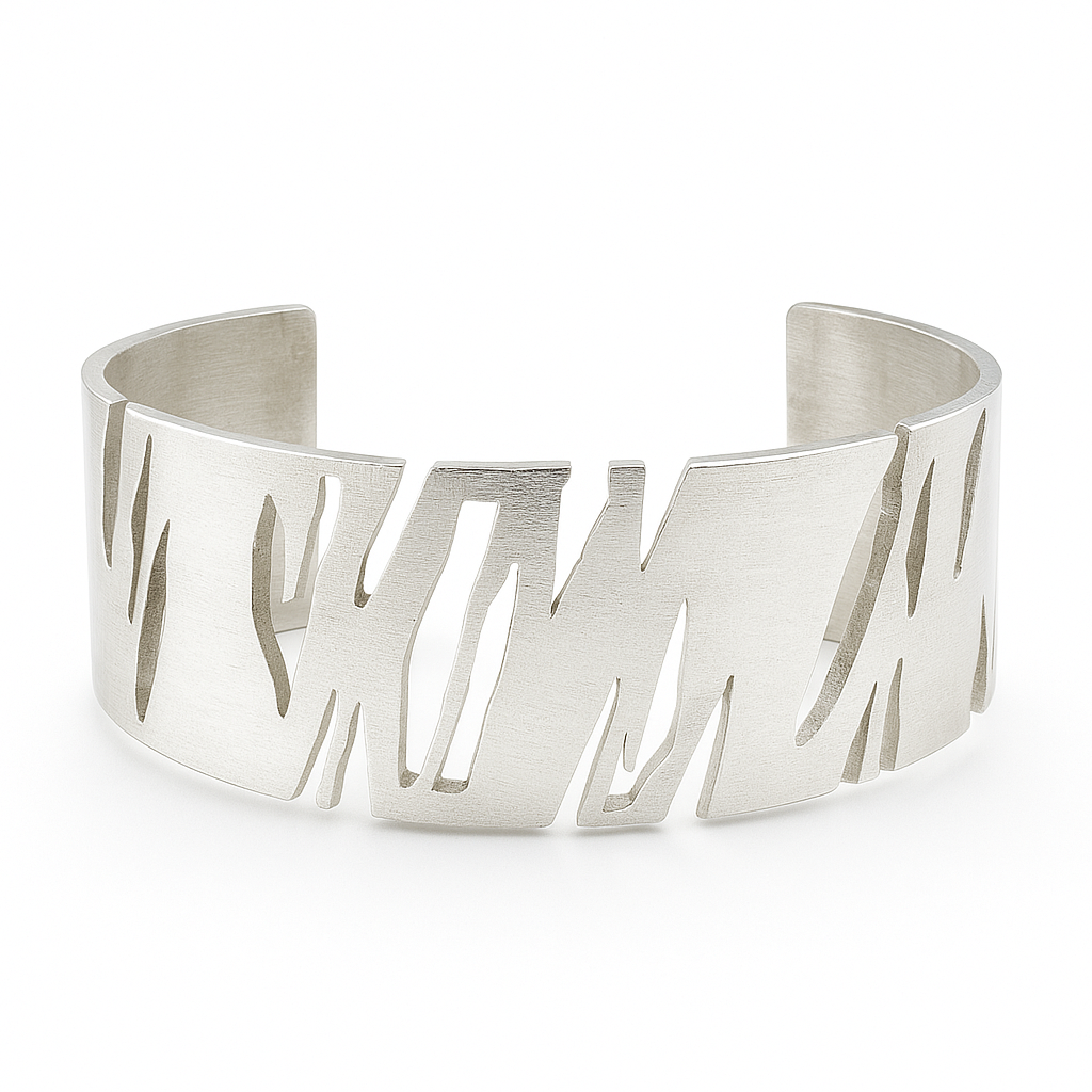 Silver cuff bracelet with cut-out design on a white background