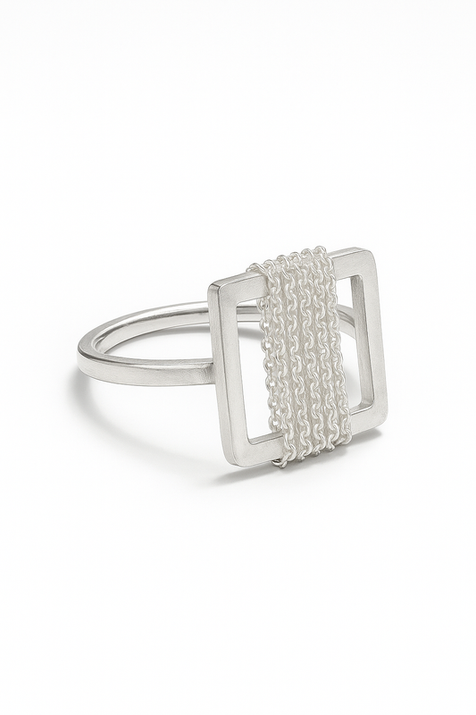 Silver ring with a square design on a white background